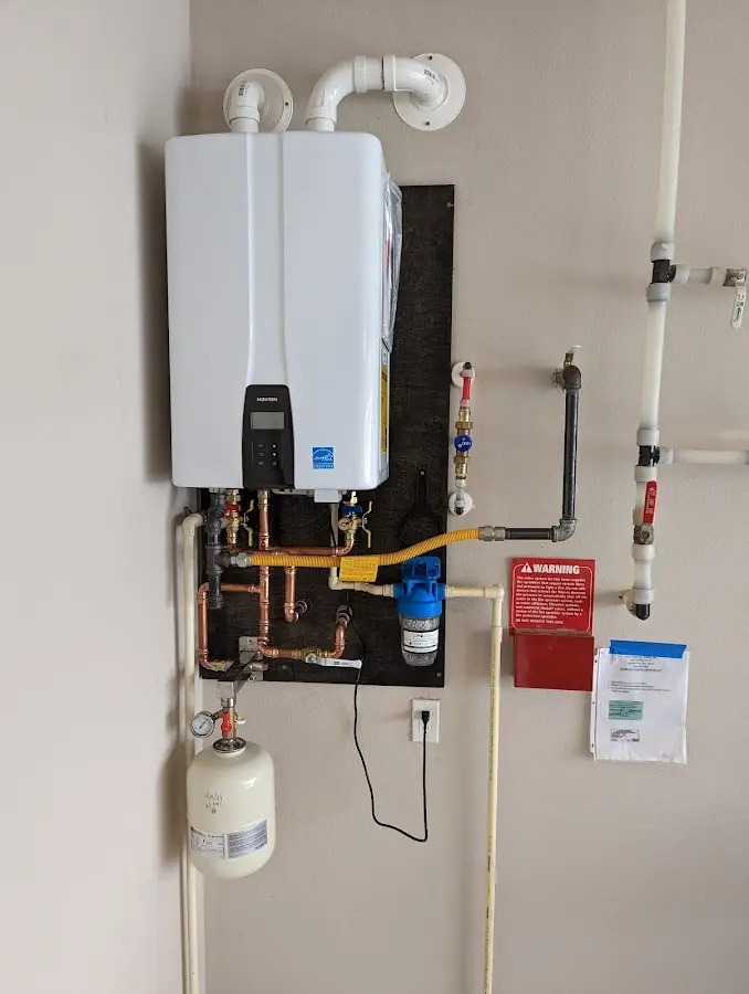 Professional plumber installing copper piping in a West Seneca home